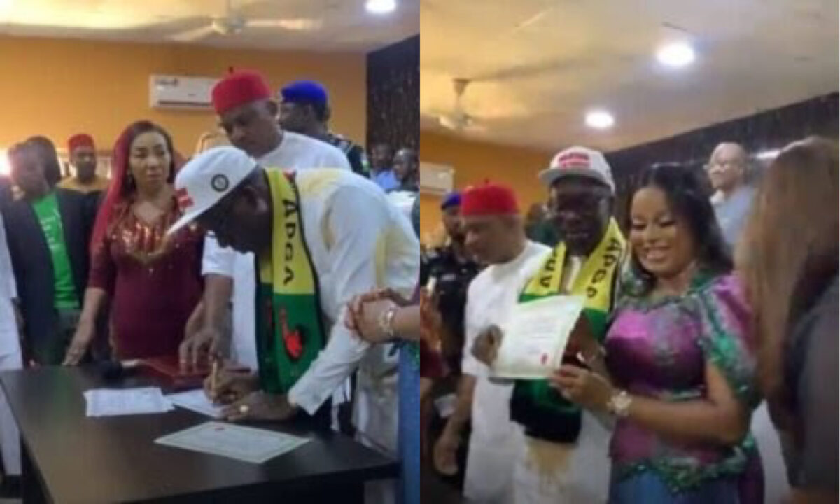 Soludo with INEC officials signing the Certificate of Return