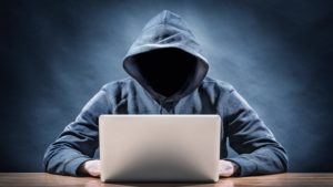 A hacker on a computer used to illustrate the story.