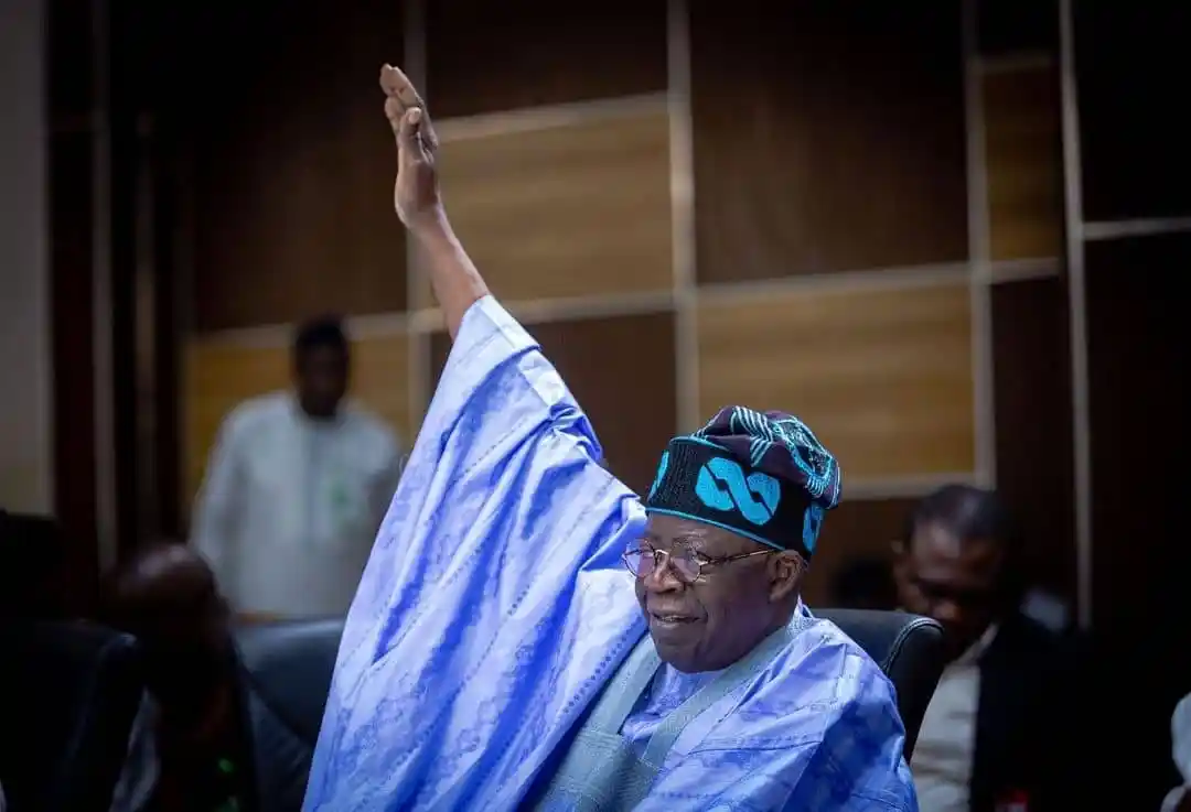 Tinubu waving hands