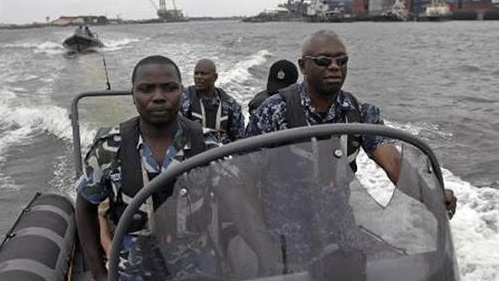 Navy officials on speedboats