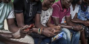 Nigerian youth using phones