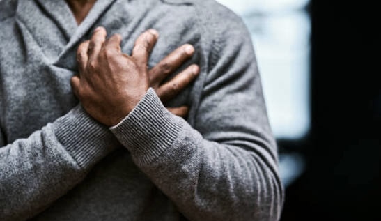 A man holding his chest