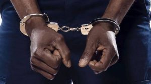 A man in handcuffs used to illustrate the story