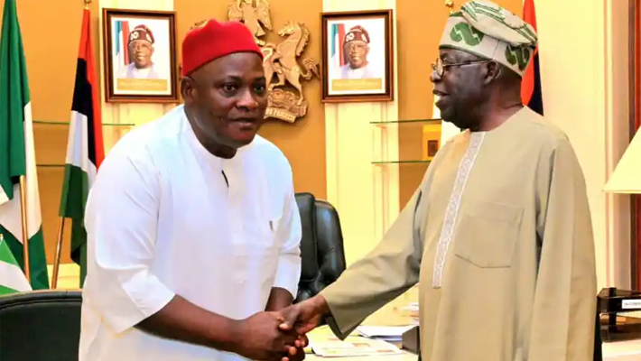 Innocent Chukwuma shaking hands with Tinubu