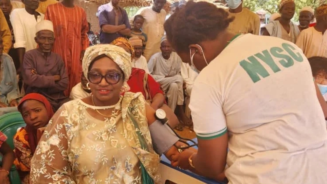 An NYSC member checking a community member' BP (Credit: NAN)