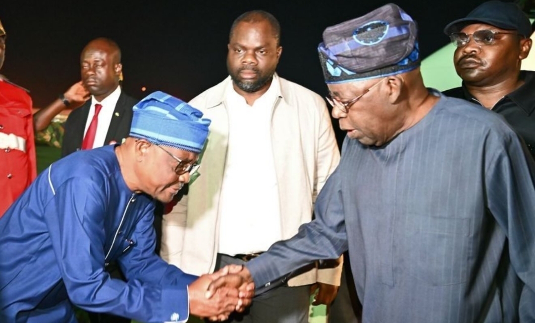President Bola Tinubu shaking FCT minister Nyesom Wike at the airport (Credit: NAN)