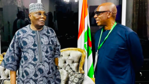Atiku standing with Amaechi