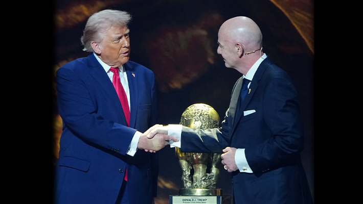 Trump with World Cup standing with FIFA president, Folarin