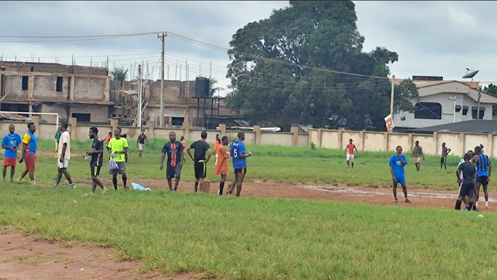youths playing football on the field of Uselu Secondary School,