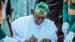 Tinubu signing a document