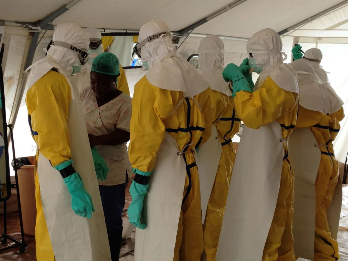 WHO health workers in protective gear .