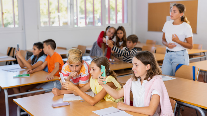 Primary school kids using phones in Poland