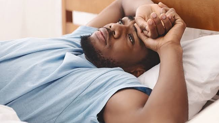 An individual on bed unable to sleep