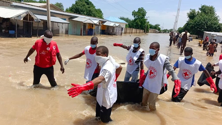 Red Cross staff evacuating people