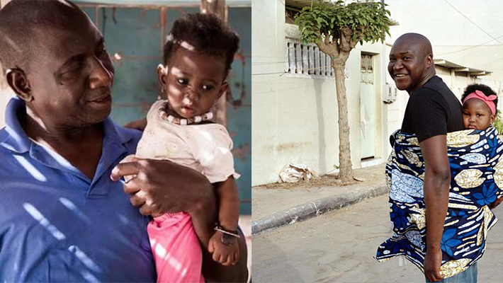 man carrying a baby