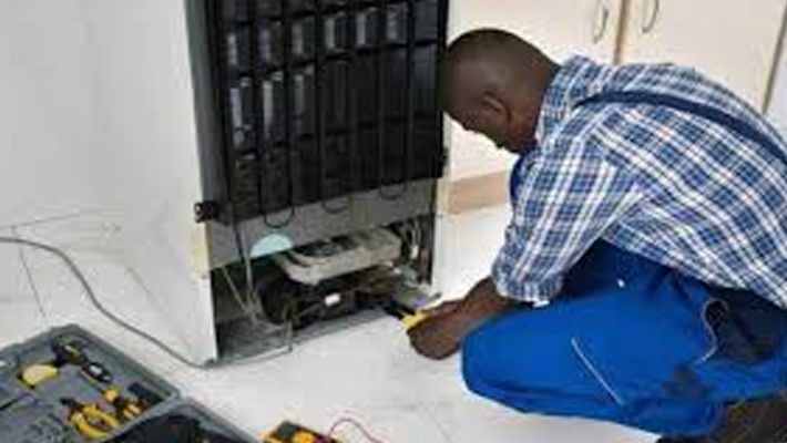 A technician repairing a home appliance