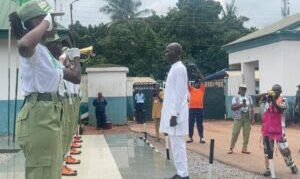 Delta Commissioner for Youth Development, Mr Brave Enodeh, taking salute on Friday at the swearing-in ceremony of Batch B, Stream II, corps members at the NYSC Orientation Camp, Issele-Uku.